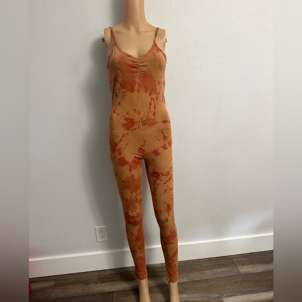 Dharma Co jumpsuit with a tie-dye pattern in shades of orange and neutral shade